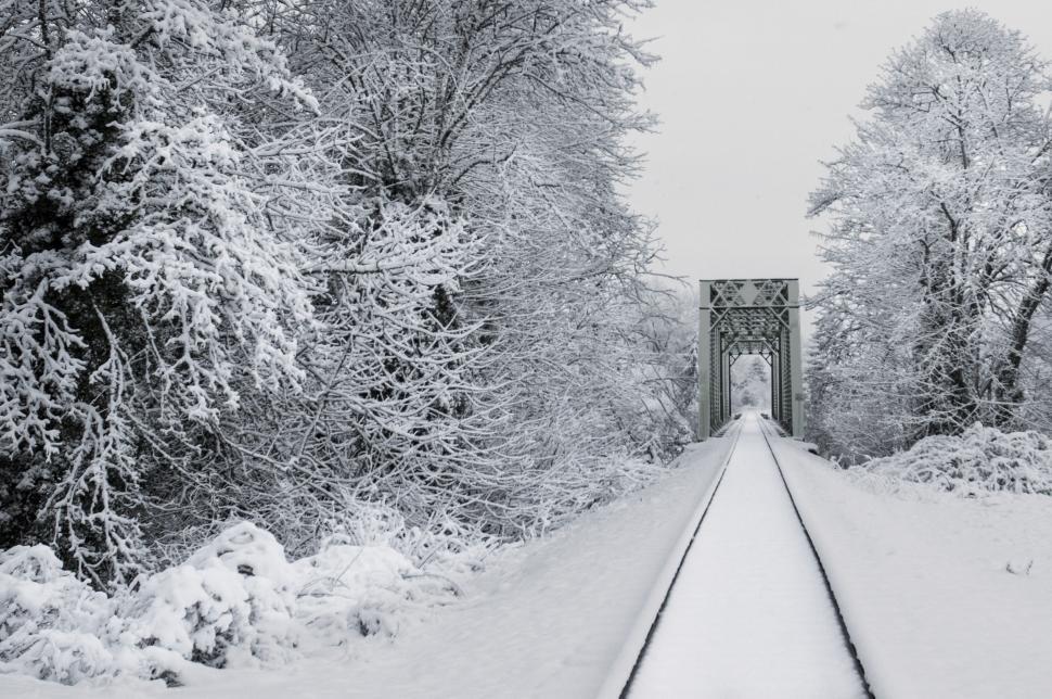Free Image of A train tracks covered in snow 