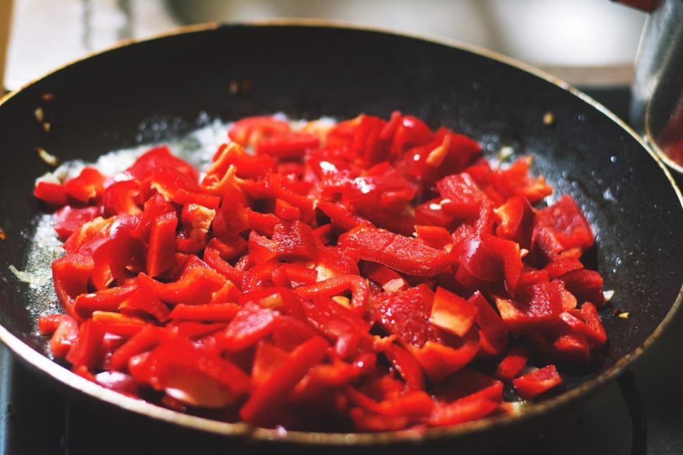 Free Image of A pan of red peppers cooking 