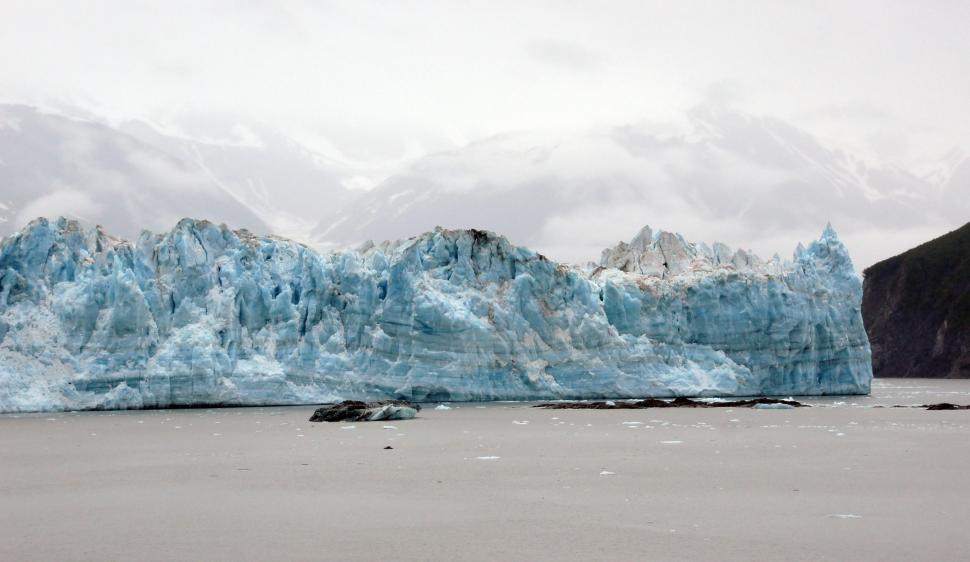 Free Image of A large iceberg in front of a body of water 