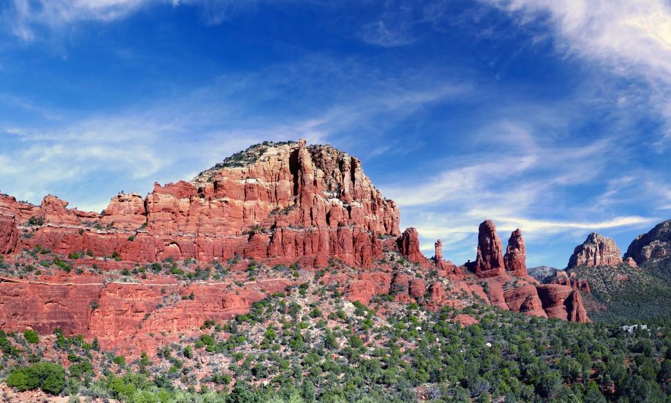 Free Image of A red rock mountain with trees and blue sky 