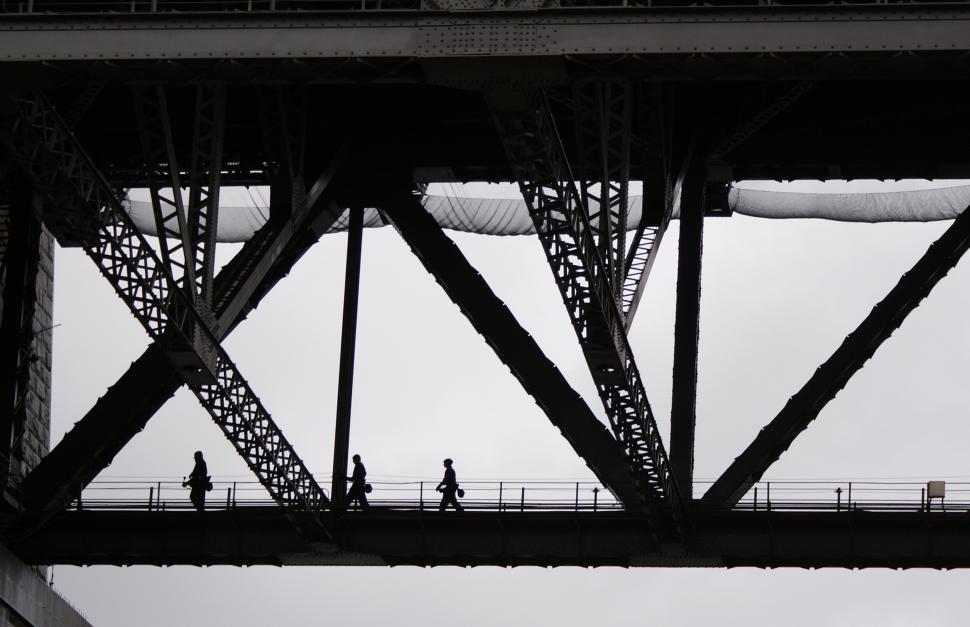 Free Image of A group of people walking on a bridge 