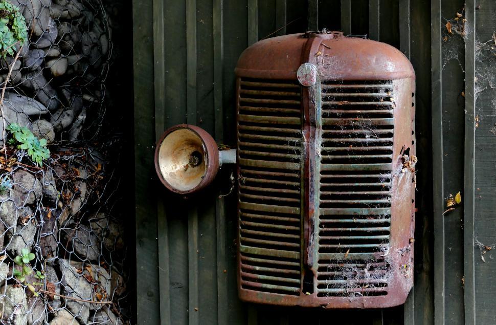 Free Image of A rusty metal grill with a speaker 