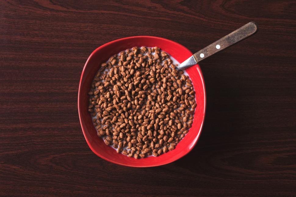 Free Image of A bowl of cereal with milk and a spoon 