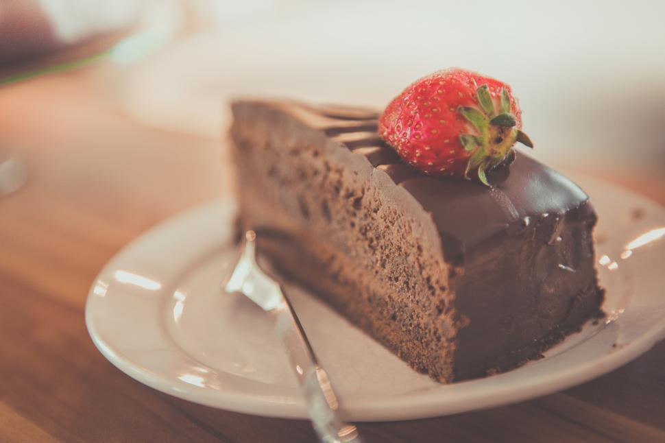 Free Image of A slice of chocolate cake with a strawberry on top 