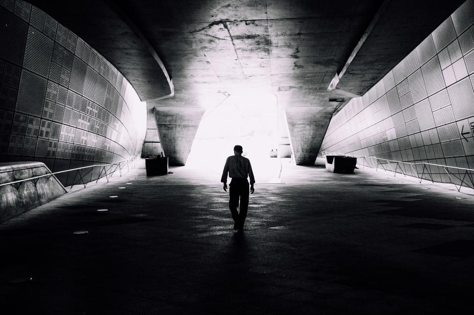 Free Image of A man walking in a tunnel 