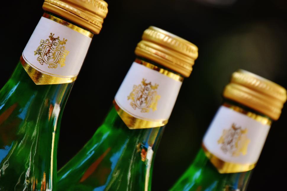 Free Image of A group of green bottles with gold caps 