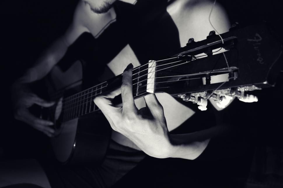 Free Image of A person playing a guitar 
