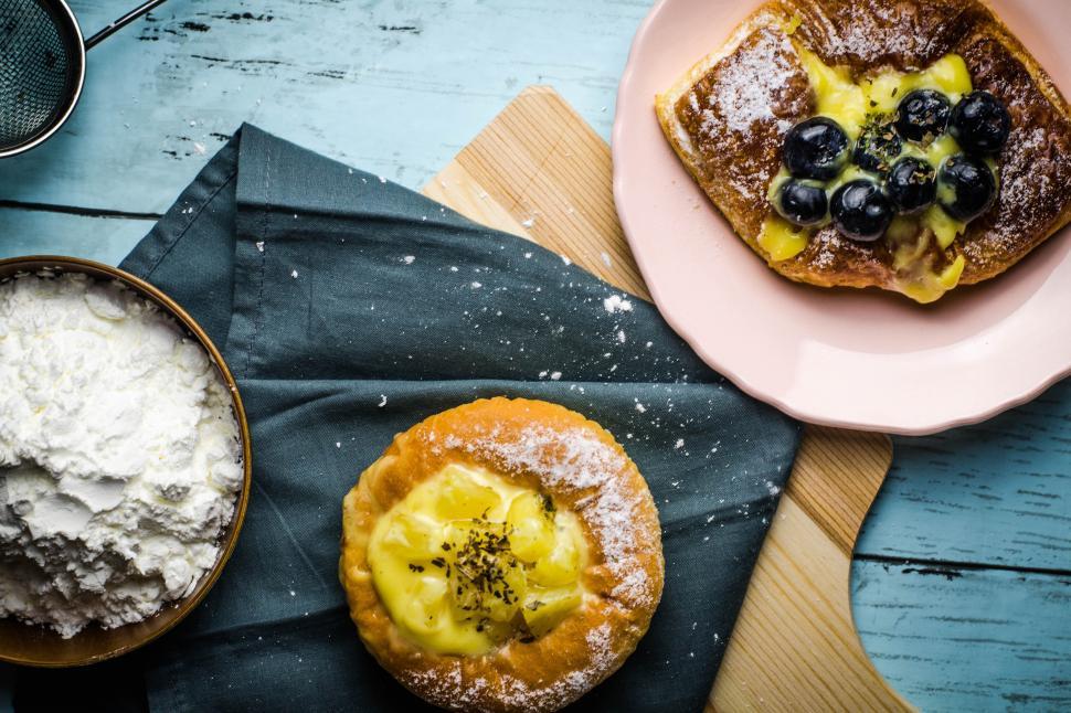 Free Image of A plate of pastries and a bowl of powdered sugar 