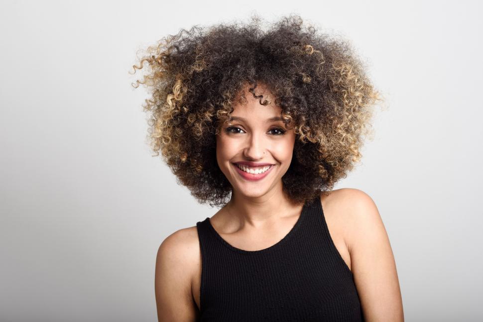 Free Image of Young black woman with afro hairstyle smiling 