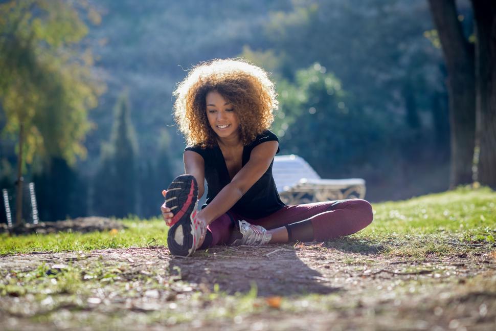 Free Image of Fitness black woman runner stretching legs after run 