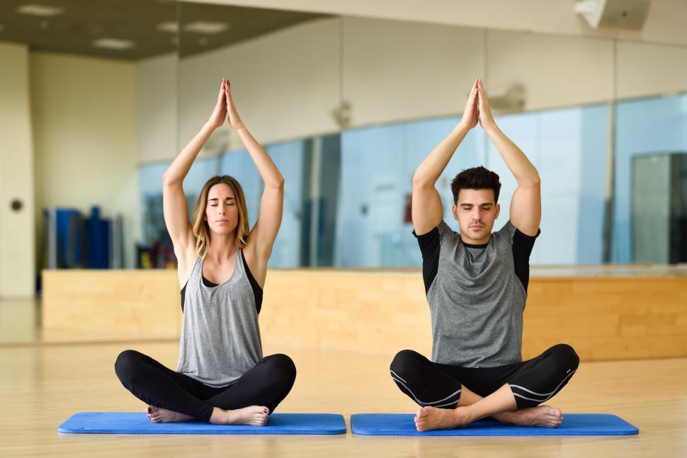 Free Image of Young woman and man practicing yoga indoors 