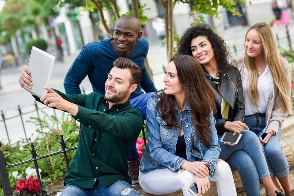 Free Image of Multi-ethnic young people taking selfie together in urban background 