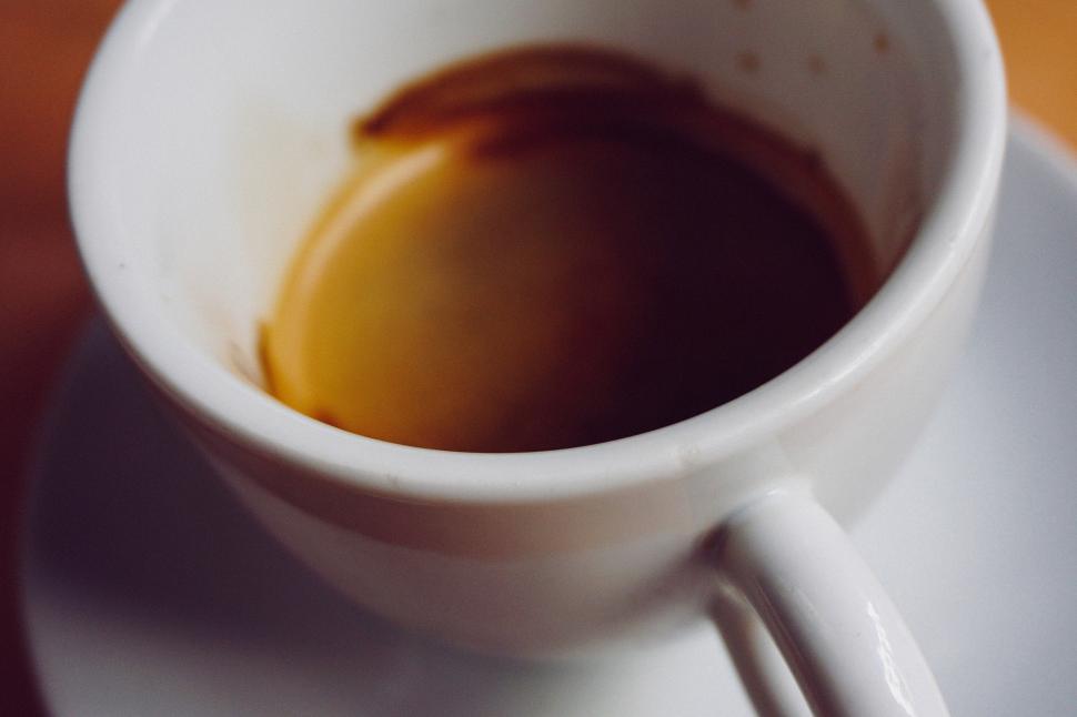 Free Image of A cup of coffee with a brown liquid in it 