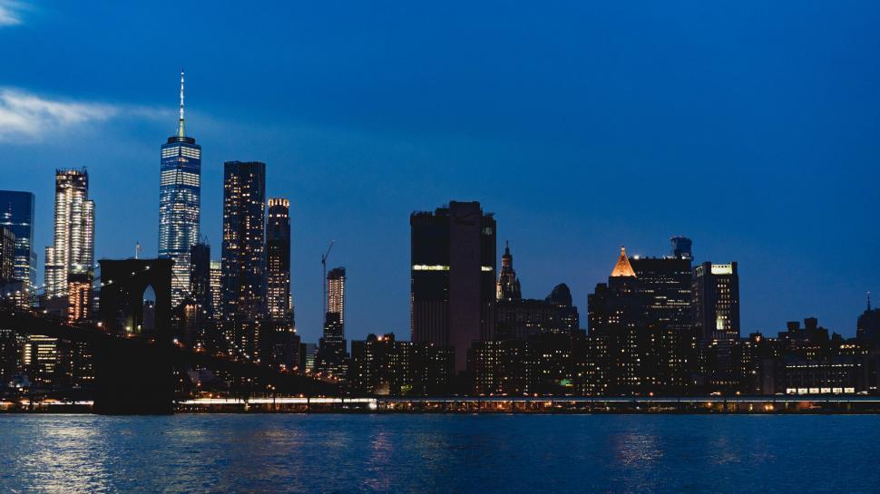 Free Image of New York city skyline at night with water in the background 