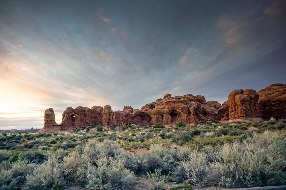 Free Image of A landscape with a large rock formation 
