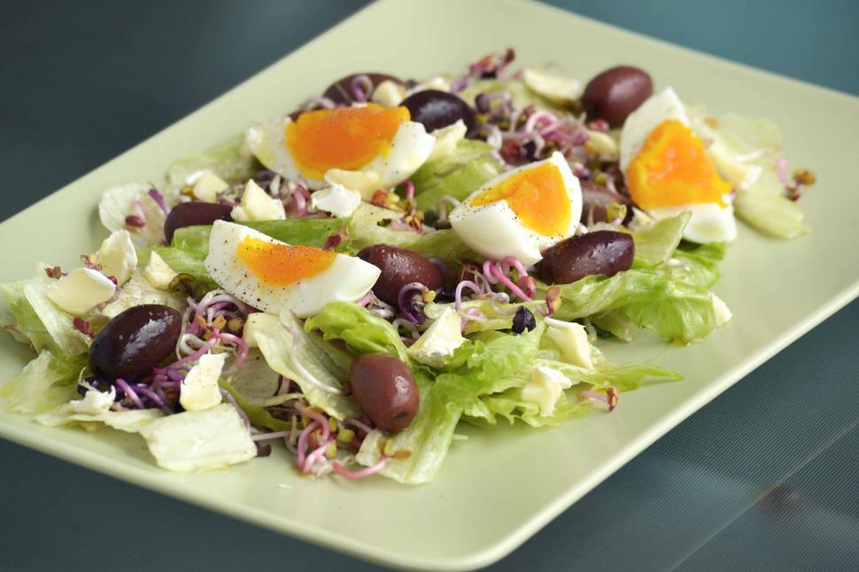 Free Image of A plate of salad with eggs and olives 