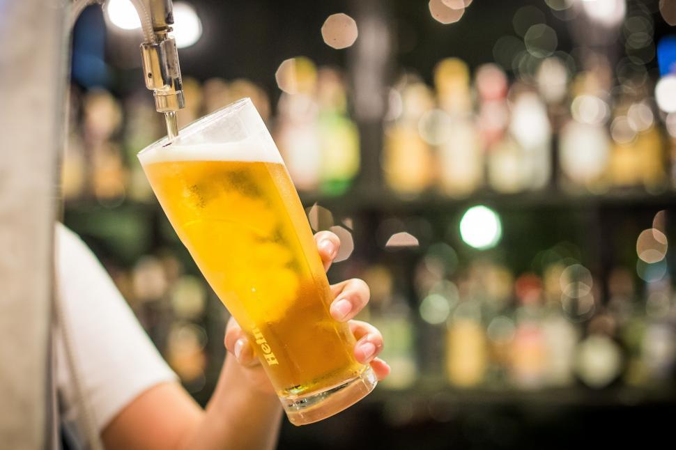Free Image of A person pouring a beer into a glass 