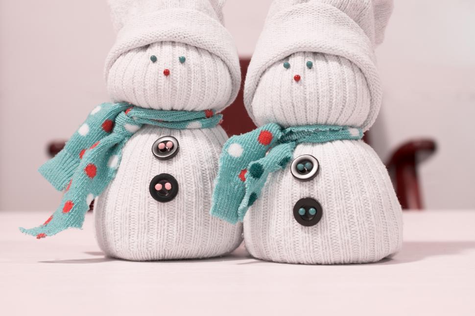 Free Image of Two snowmen made of socks and hats 