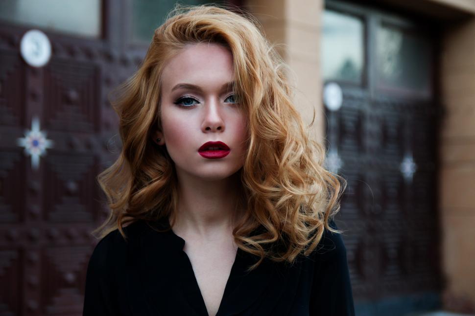 Free Image of A woman with red hair and red lipstick 