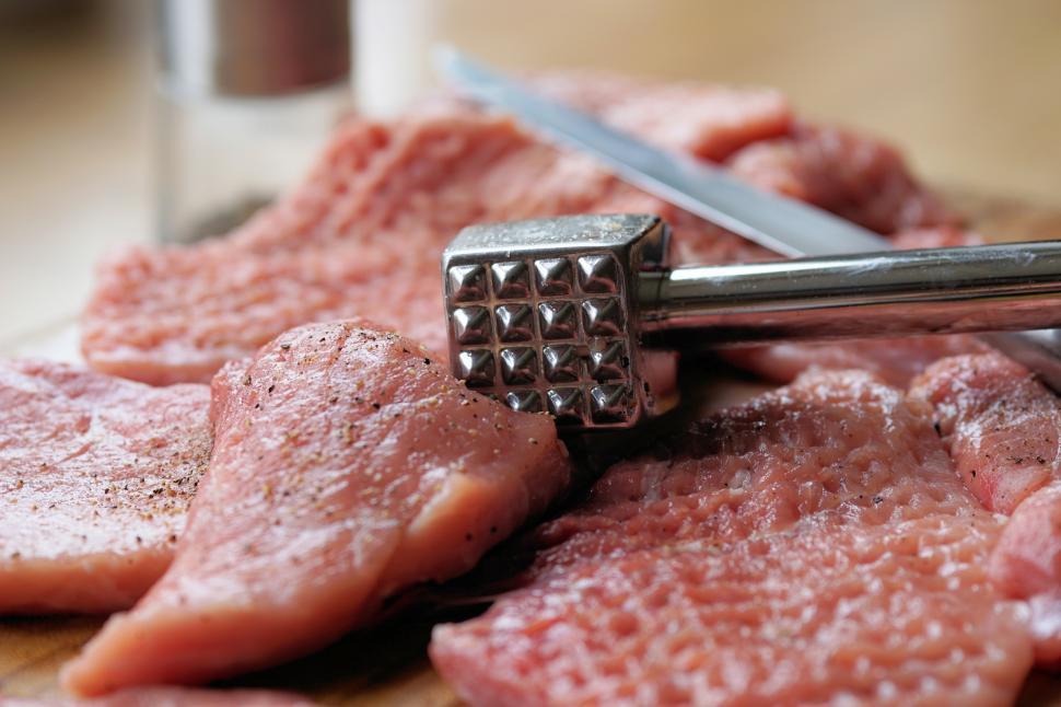 Free Image of Meat with a hammer on top of it 