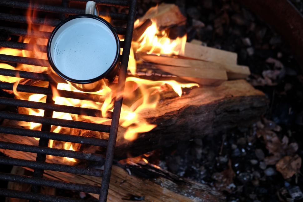 Free Image of A mug on a grill over a fire 