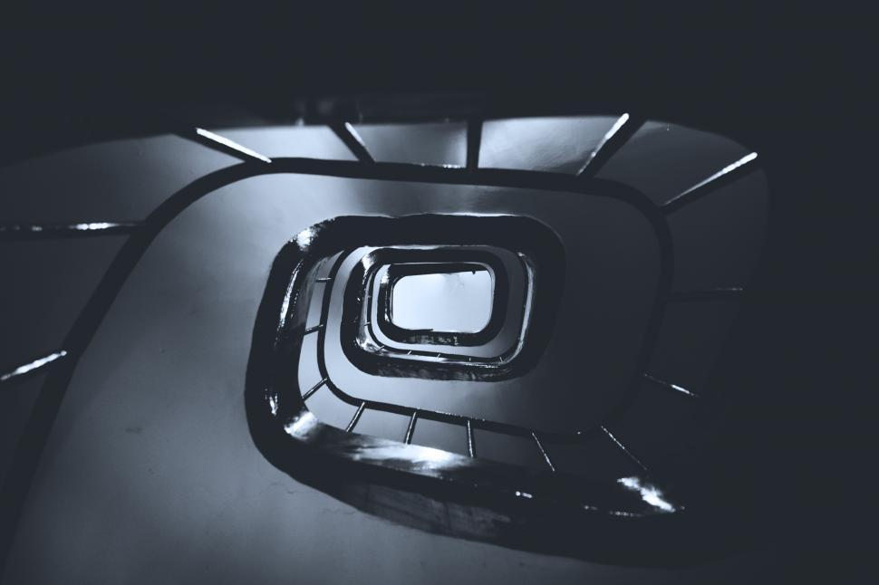 Free Image of A spiral staircase with a light shining on it 