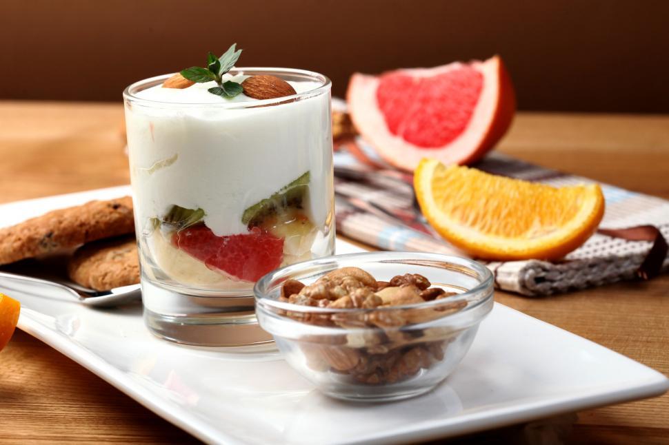 Free Image of A dessert in a glass with fruit and nuts 