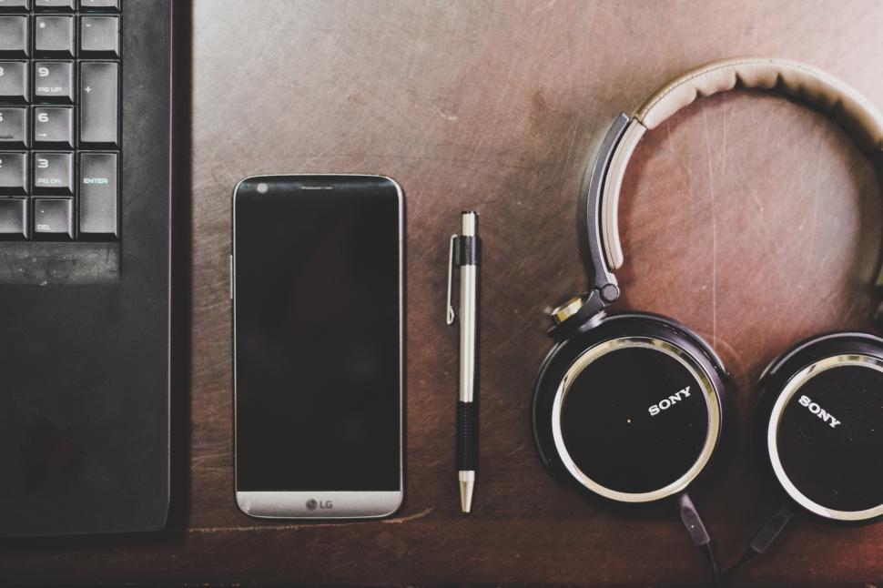 Free Image of Laptop, Pen, Mobile and Music Headphones Free Stock Photo 