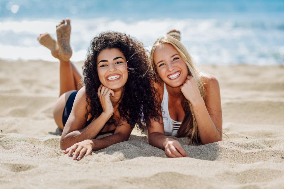 Free Image of Two happy young women in swimsuit on a tropical beach 