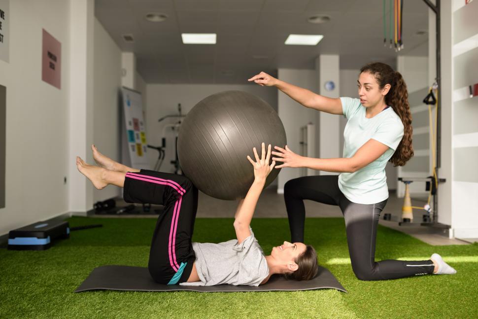 Free Image of Physical therapist assisting young caucasian woman with exercise 