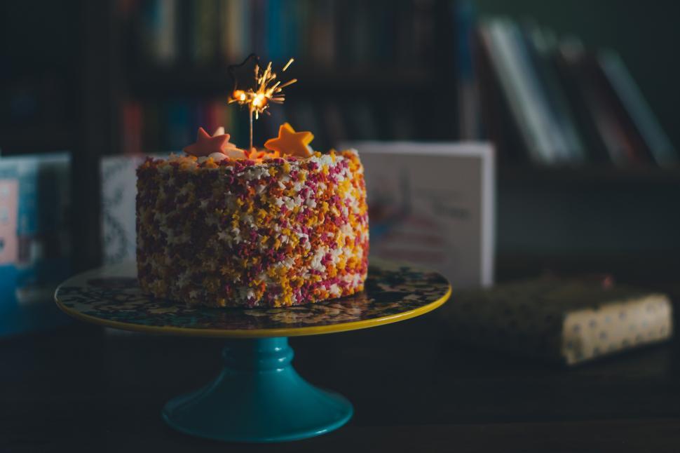 Free Image of A cake with a sparkler on top 