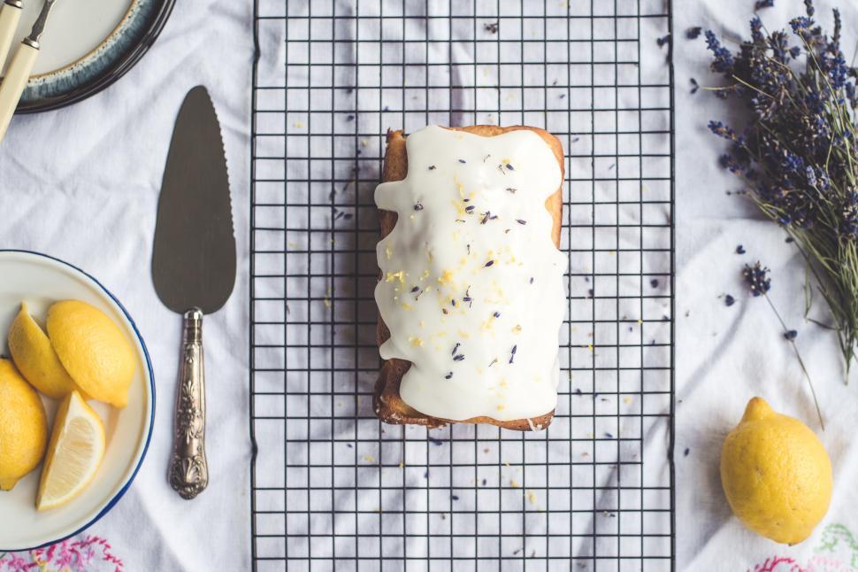 Free Image of A loaf of bread with white frosting on a grid 