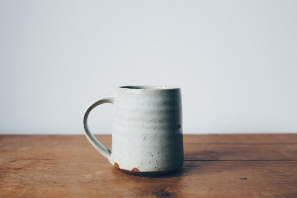 Free Image of A white mug on a wood surface 