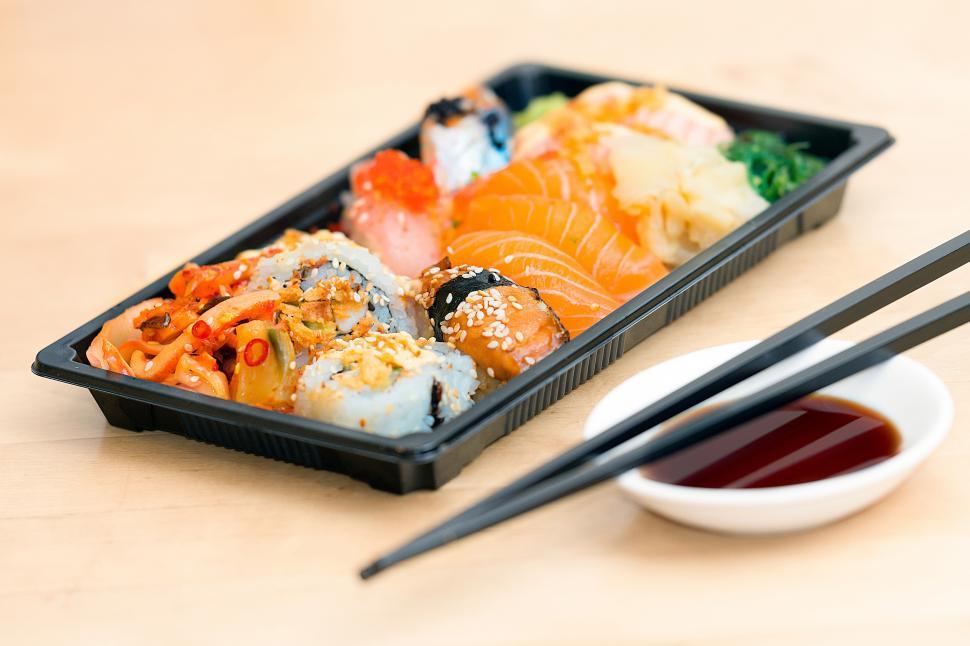 Free Image of A tray of sushi with chopsticks 