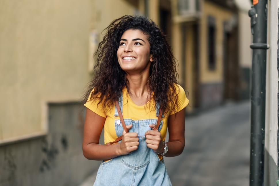 Free Image of Young North African woman with black curly hairstyle outdoors. 