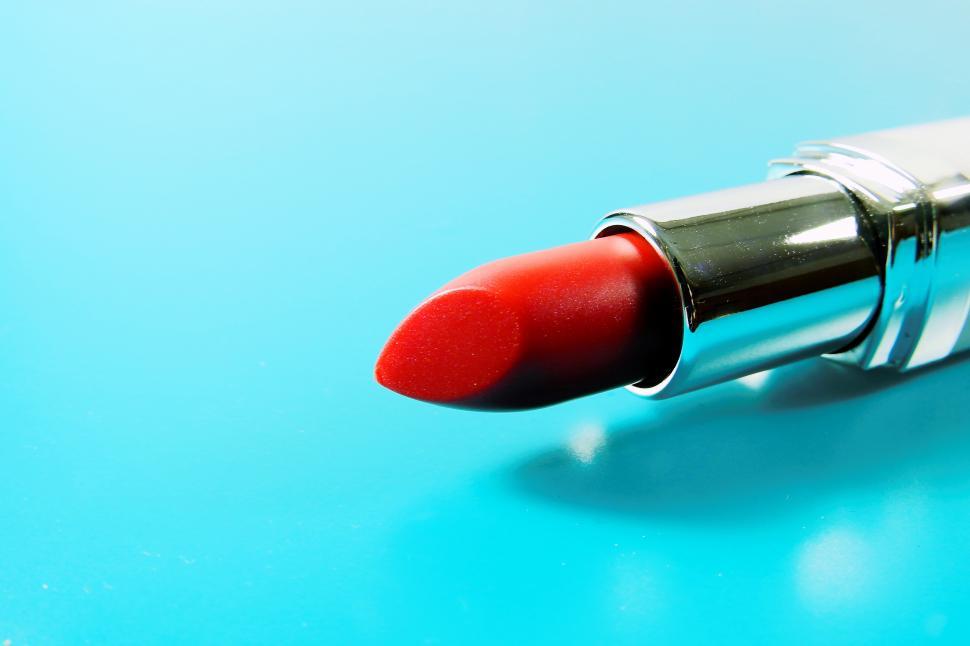 Free Image of A red lipstick on a blue surface 