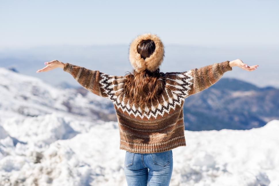 Free Image of Young woman enjoying the snowy mountains in winter 