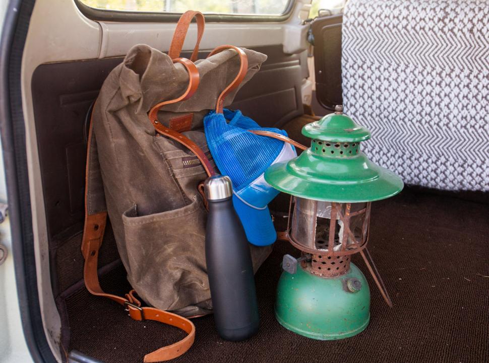 Free Image of A bag and a lantern in a car 
