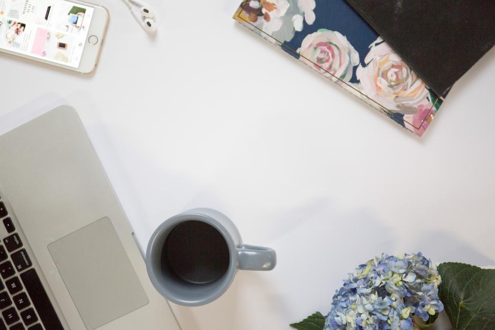 Free Image of A laptop and a mug on a white surface 