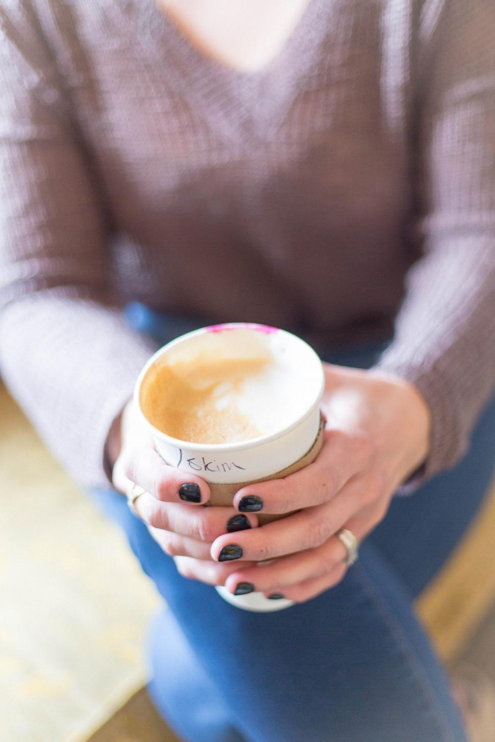 Free Image of A person holding a cup of coffee 