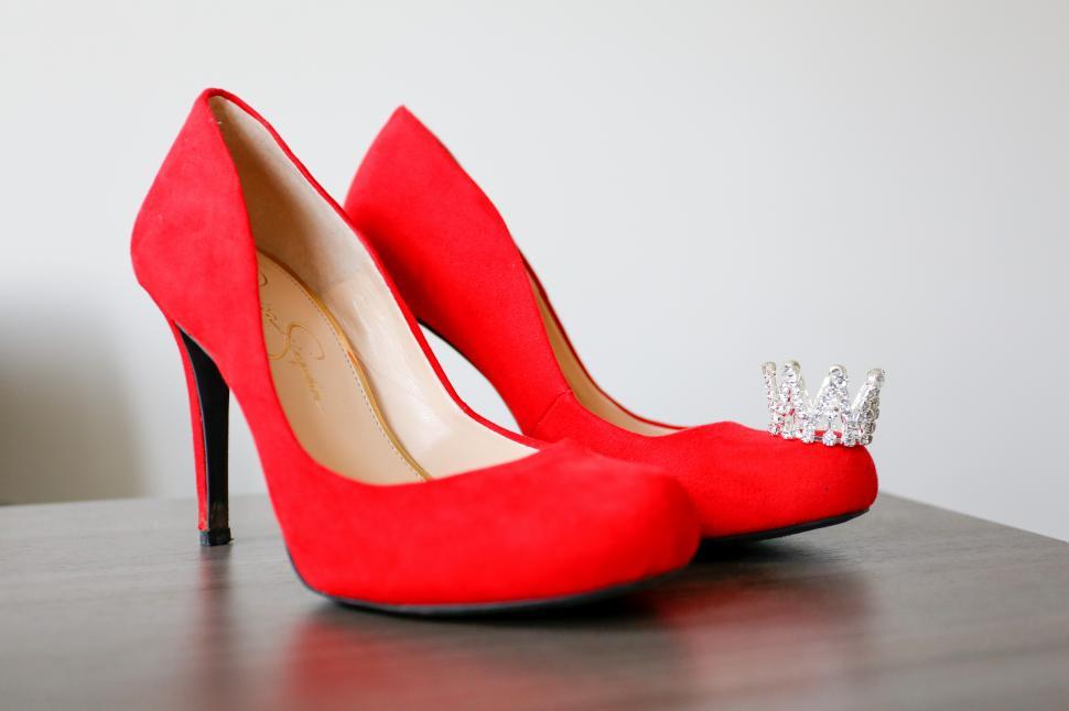 Free Image of A pair of red high heeled shoes with a crown on top 