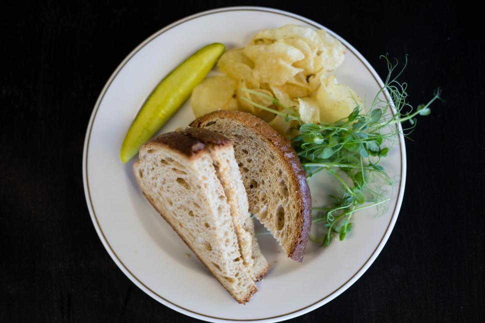 Free Image of A plate of food with a sandwich and potato chips 