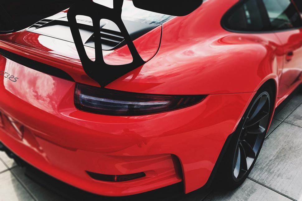 Free Image of The back of a red sports car 