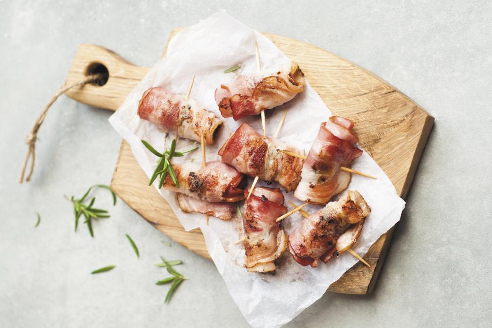 Free Image of Bacon wrapped meat on a wooden board 