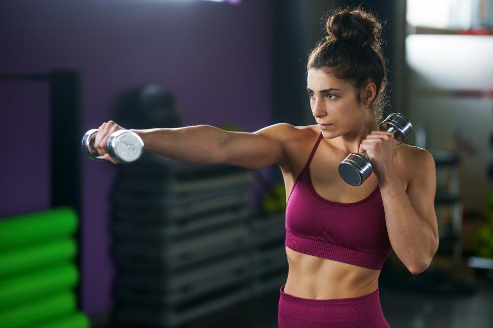 Free Image of Sporty woman punching and boxing with dumbbells. 