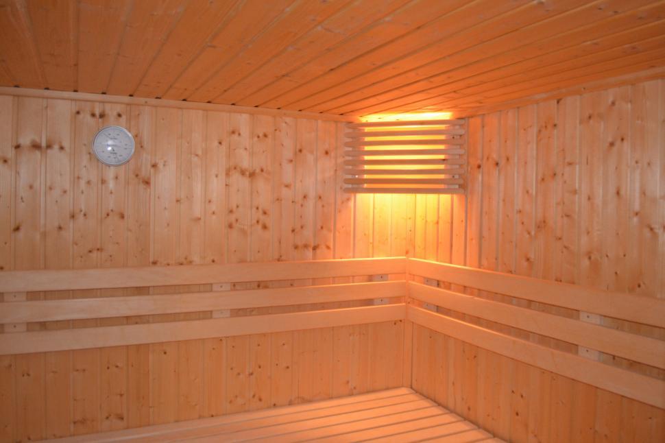 Free Image of A wooden sauna with a light 