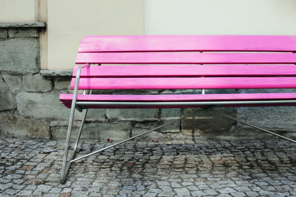 Free Image of A pink bench on a stone surface 