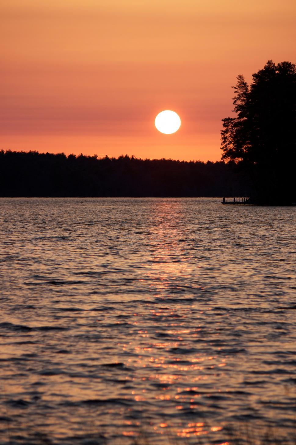 Free Image of A sunset over a lake 