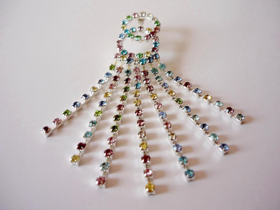 Free Image of Multicolored Beaded Necklace Hanging From a Hook 