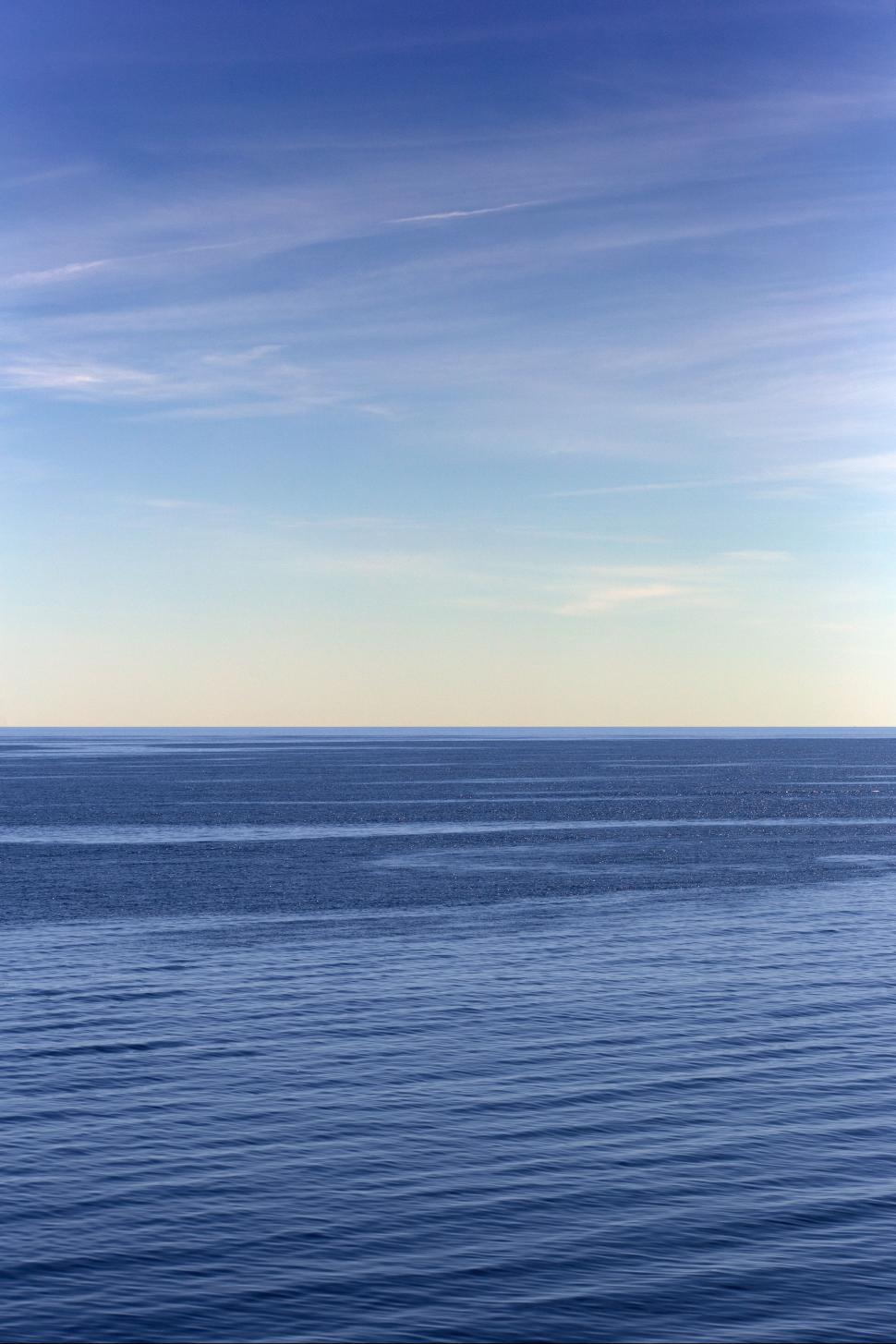 Free Image of A body of water with blue sky and clouds 